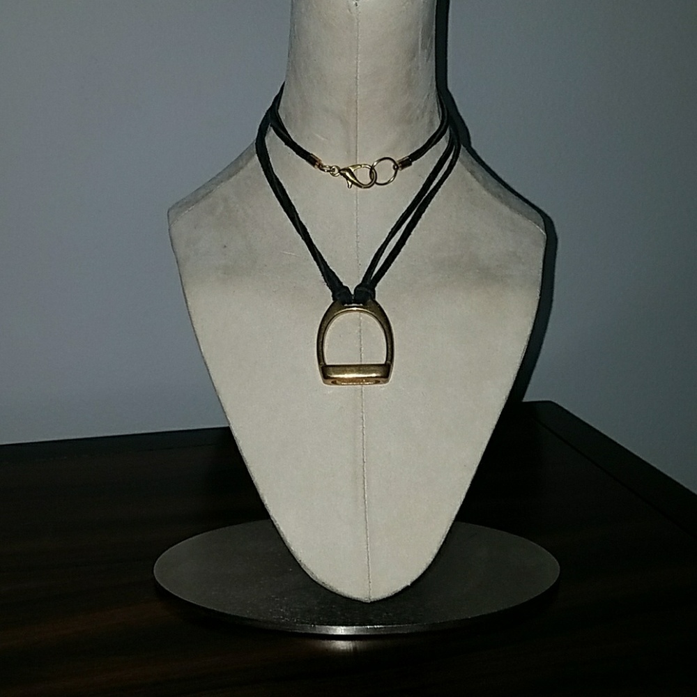 Gold brass pendant with leather cord.